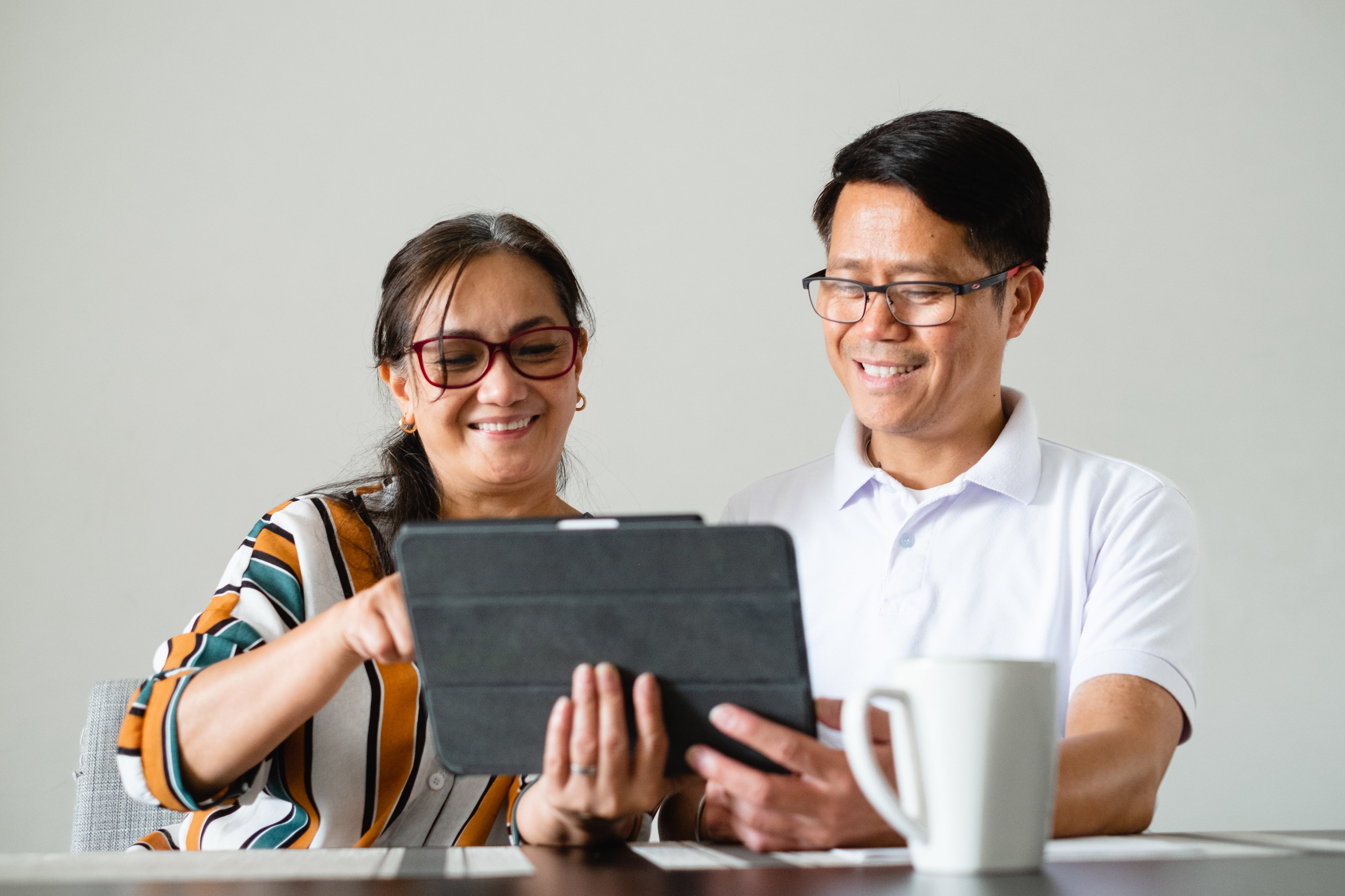 couple-smile-as-the-use-a-tablet.jpg